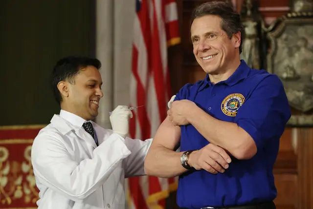 Governor Cuomo receives a flu shot from Health Commissioner, Dr. Nirav Shah, to enourage all New Yorkers to guard against a bad flu season, in 2013